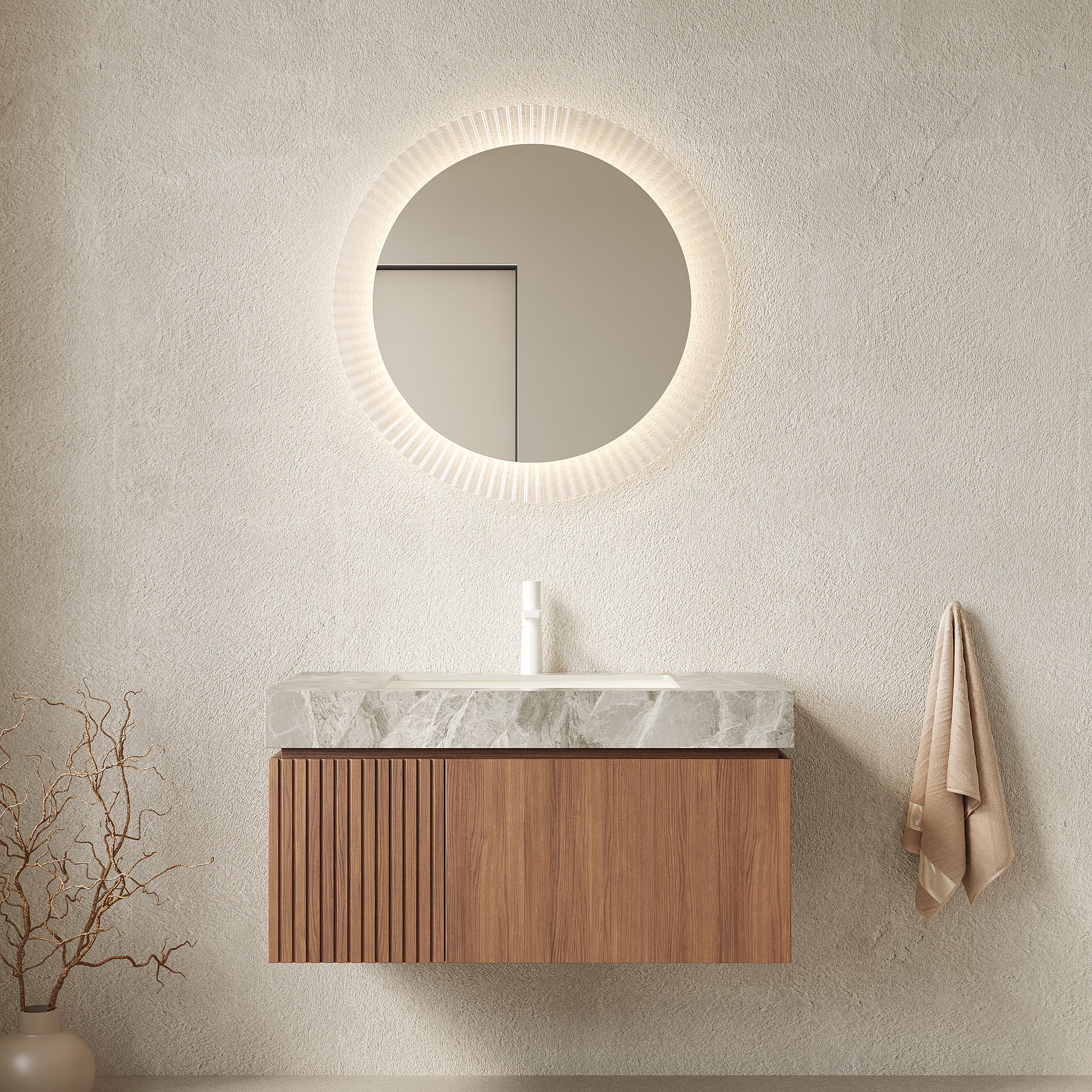 Bathroom vanity with round mirror and wooden cabinet against a beige wall.