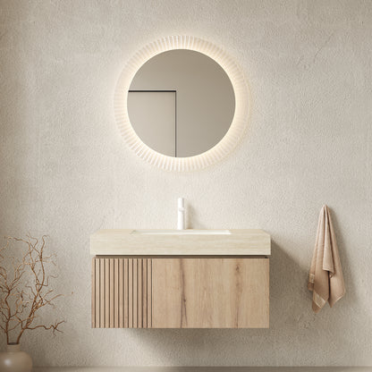 Bathroom setup with wooden vanity, round mirror, and towel on a neutral wall.