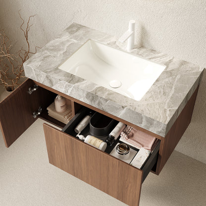 Bathroom vanity with marble countertop and open drawer showing toiletries.