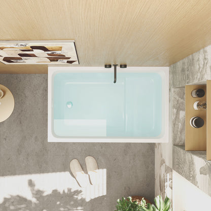Modern bathroom with a bathtub filled with water, towels, and plants.
