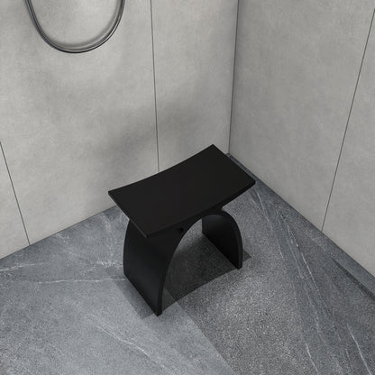 matte white shower stool next to a bathtub