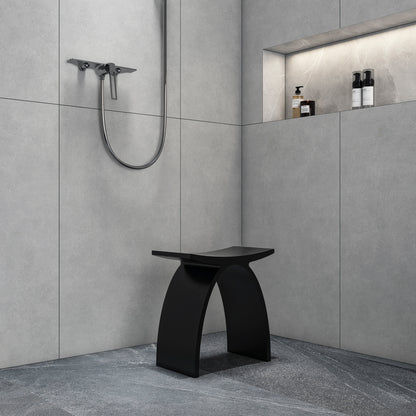 matte black compact shower stool in a small bathroom