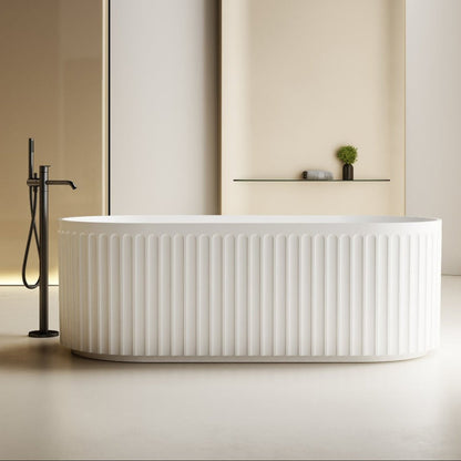 Modern white freestanding bathtub with a black faucet in a minimalistic bathroom.