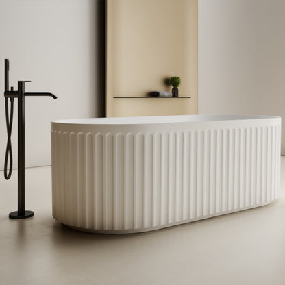 Modern white freestanding bathtub with black faucet in a minimalistic bathroom.
